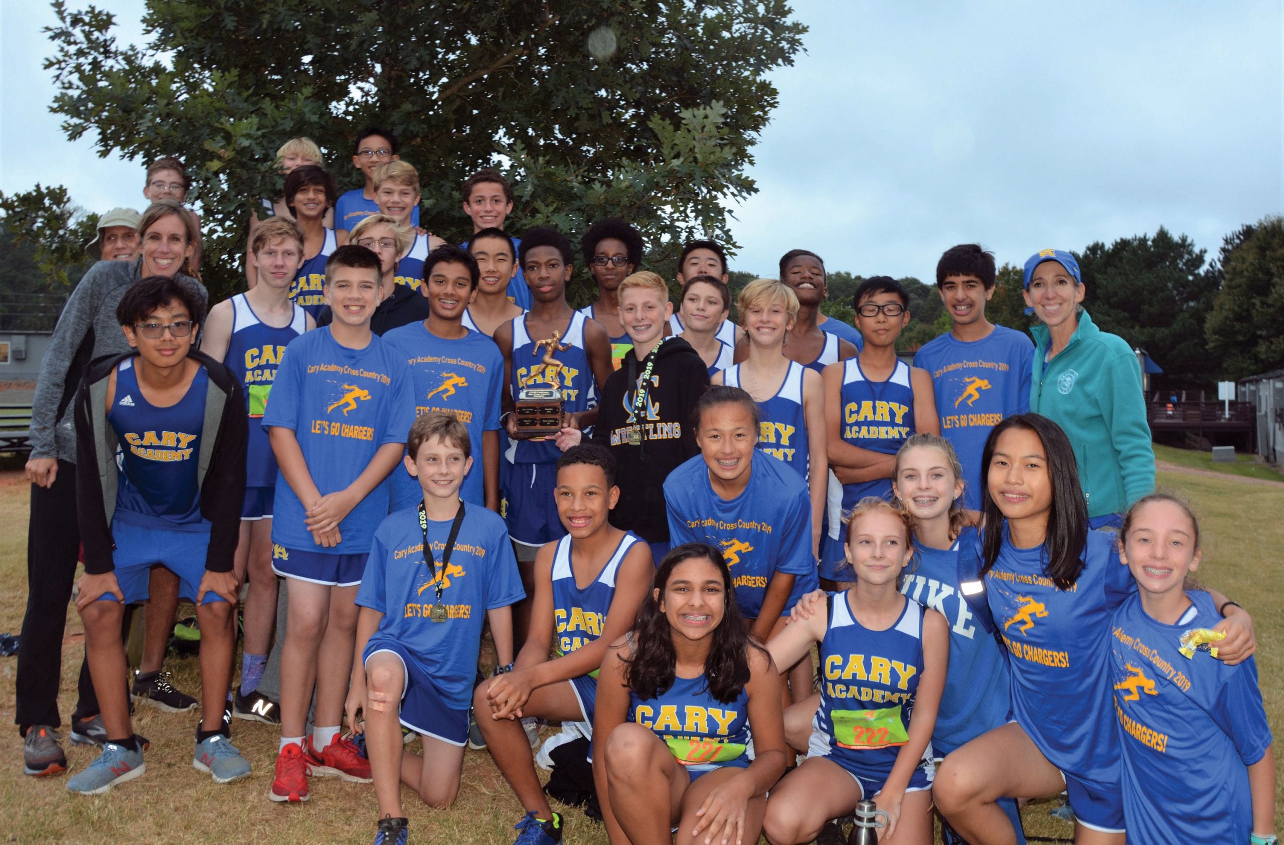 Middle School cross country team with trophy