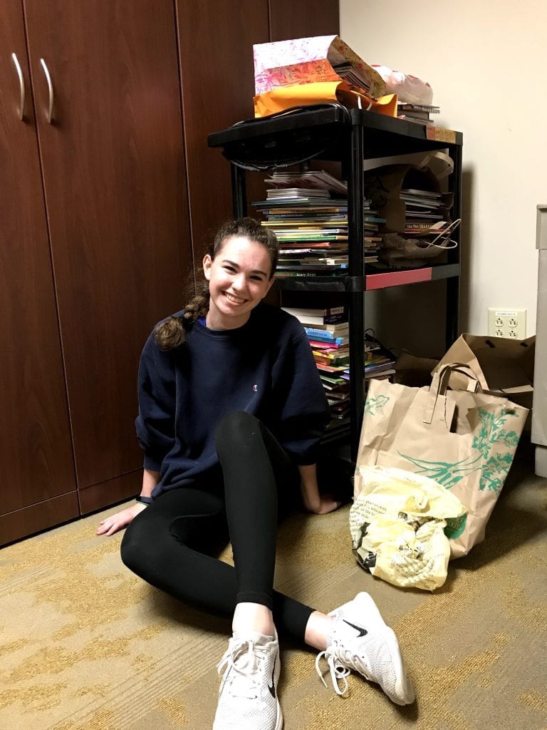 Ellie McMahon '21 with books during the book drive