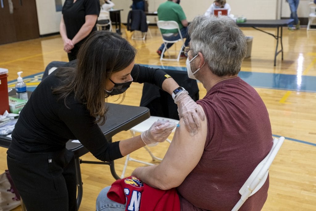 A member of the CA faculty receives an injection at the CA COVID vaccination clinic