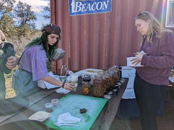 A group of women standing around a table with food on it

Description automatically generated with low confidence